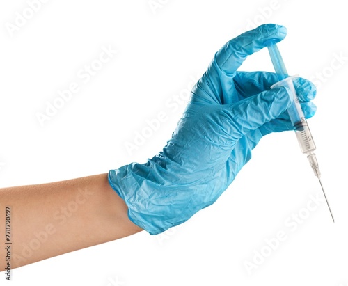 Hand holds syringe.