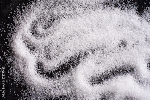 Salt or sugar close up on black background drawing