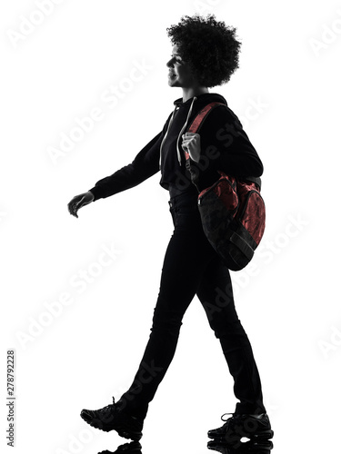 one mixed race african young teenager girl woman walking smiling in studio shadow silhouette isolated on white background