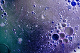 abstract background or texture with oil bubbles on purple water surface