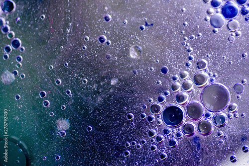 abstract background or texture with oil bubbles on purple water surface