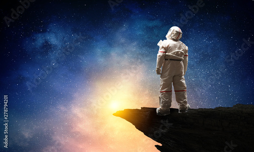 Spaceman and the planet Earth abstract theme © Sergey Nivens