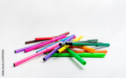 Multi-colored felt-tip pens randomly scattered on a white background. Back to school. Fine Arts Education.