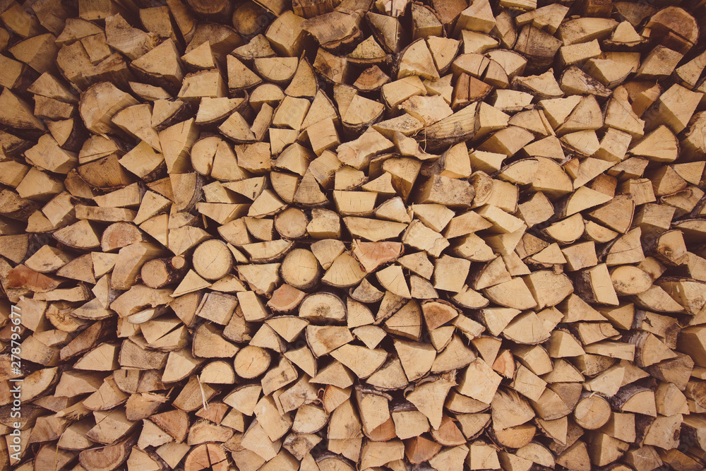 Firewood is stacked on top of each other. Firewood is harvested for heating in cold weather.