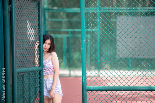 Portrait of hipsters girl pose for take a photo at tennis court,Thailand people,Lifestyle of modern thai woman