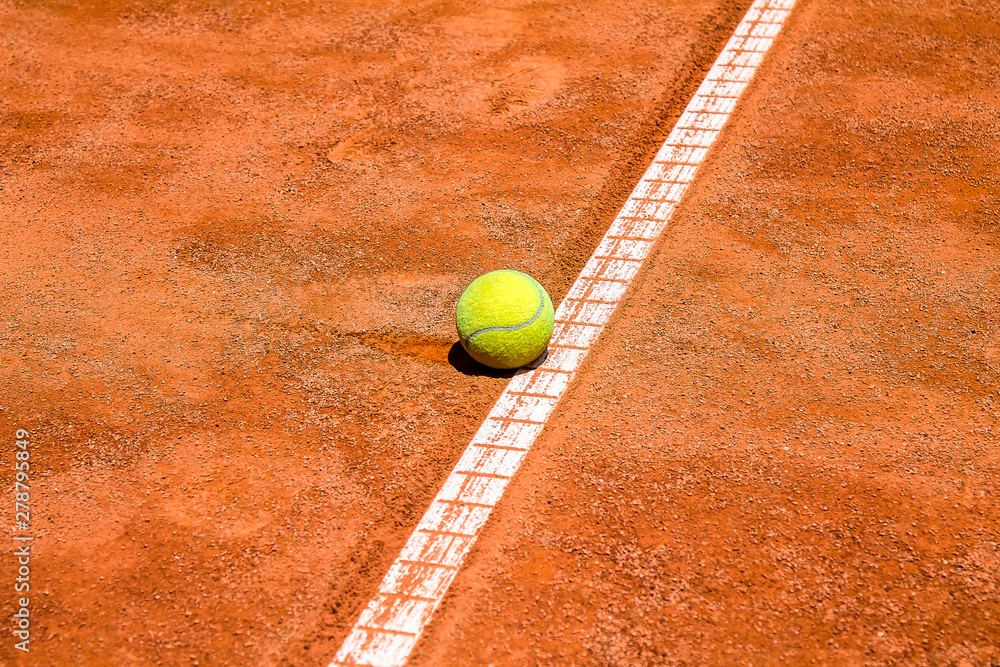 Tennis ball on a clay court close-up