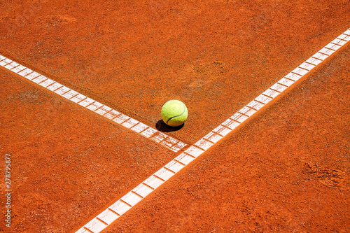 Tennis ball on a clay court close-up