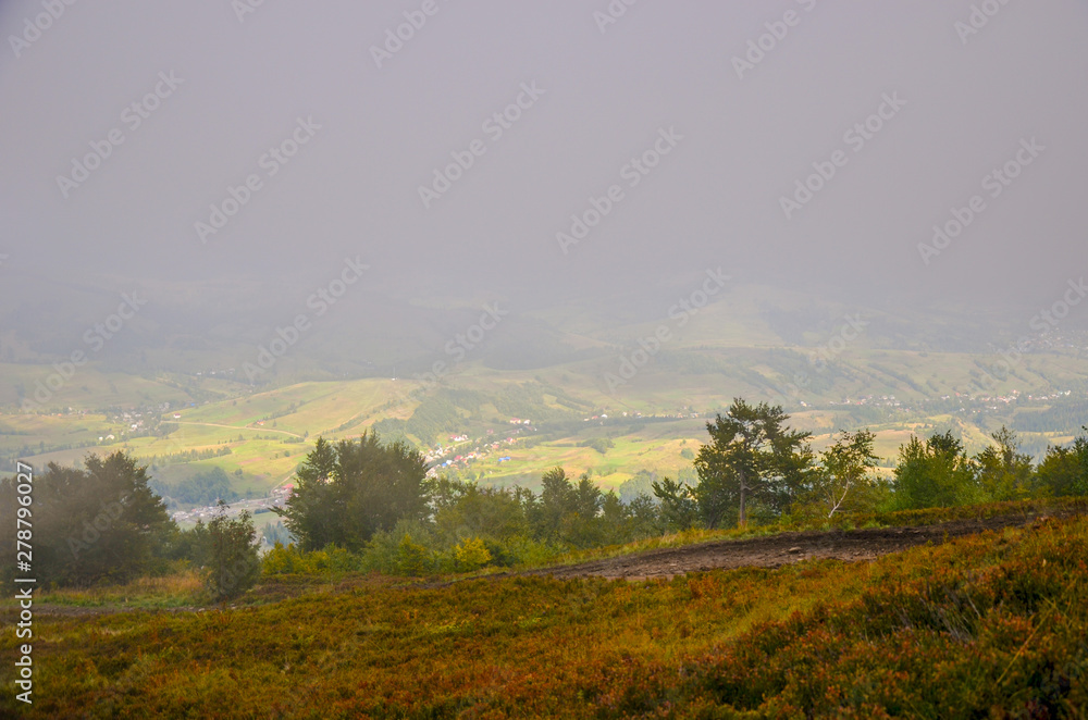 View of village covered in fog at Carpathian mountains