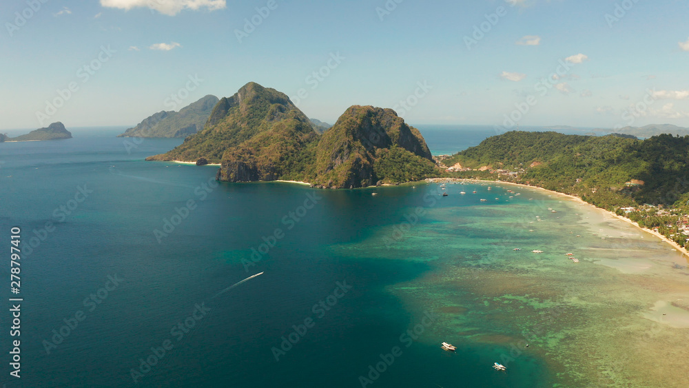 Aerial view bay with lagoon and turquoise water on a tropical island against the backdrop of the mountains. Corong corong beach, El Nido, Palawan, Philippines. Summer and travel vacation concept