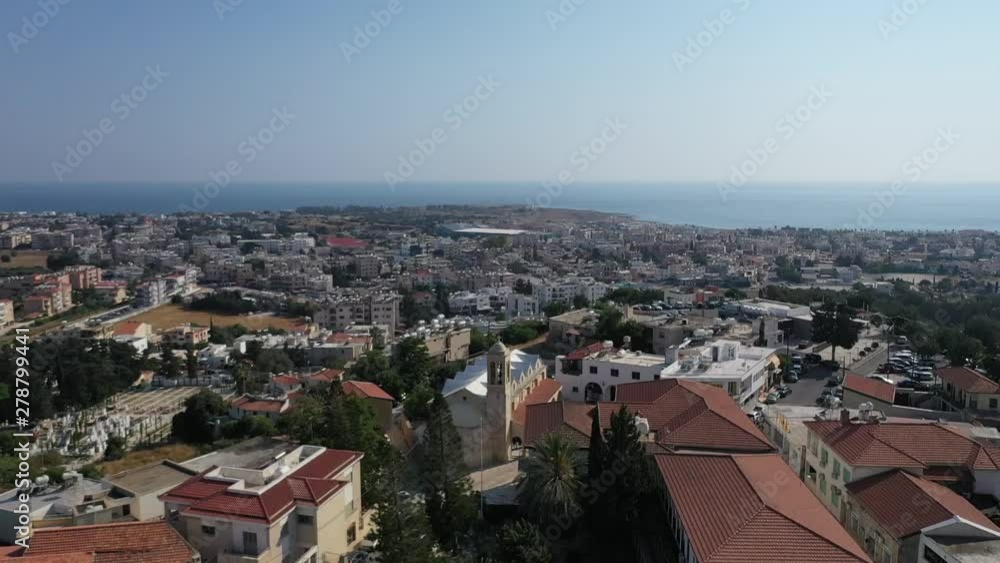 Low aerial drone shot over Paphos City, sea coast, port of Pafos and the King Avenue Mall Low aerial drone shot over Paphos City, sea coast, port of Pafos and the King Avenue Mall