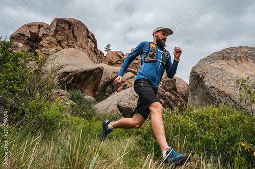 Fotografie Male runner running on a mountain trail