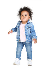 Beautiful baby girl in fashion clothing on white background