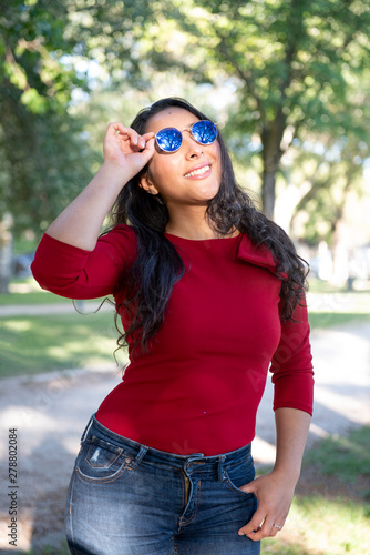Pretty Hispanic woman posing in the park © Noelia