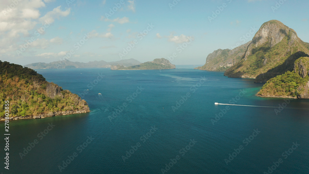 Cove with tropical rocky islands covered with rainforest, sea with blue water, aerial view. El nido, Philippines, Palawan. Tropical Mountain Range