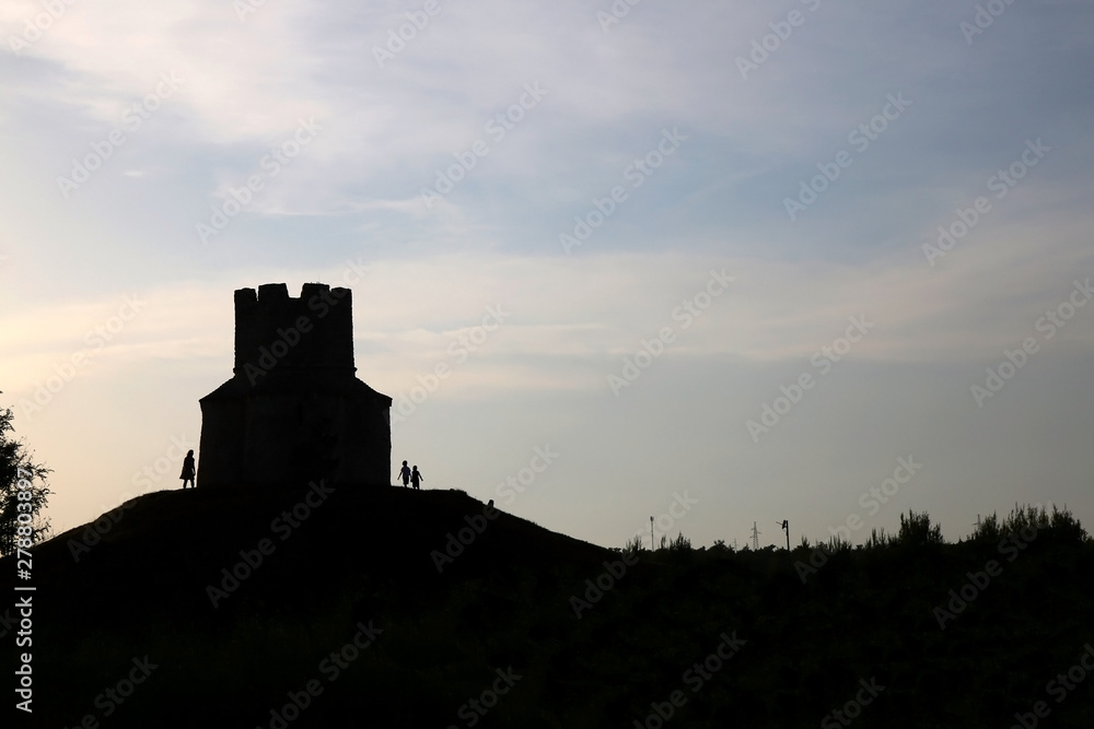 Silhouette of small medieval church of St. Nicholas and visitors around, near Nin, Croatia.