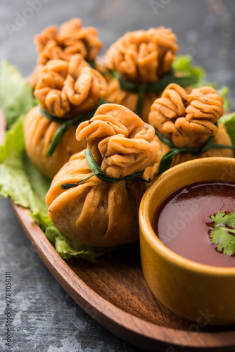 Crispy Potli Samosa or veg money bags are delicious Indian snacks of spiced aloo and mix veggies Or Meat/kheema  stuffed in flaky dough. It's a great creative starter or appetiser. served with ketchup photo