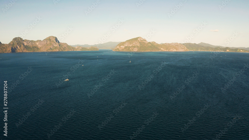 Bay and the tropical islands. Seascape with tropical rocky islands, ocean blue wate, aerial view. islands and mountains covered with tropical forest. El nido, Philippines, Palawan. Tropical Mountain