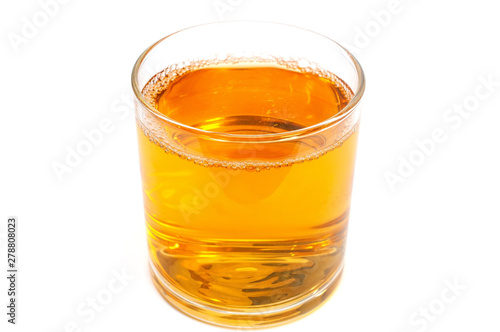 Apple juice in a glass isolated on white