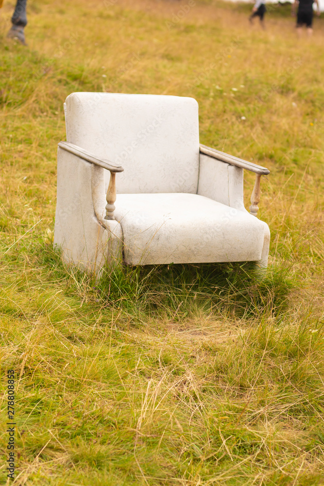 Fototapeta premium white chair on the grass sofa old relax seat comfortable furniture outdoor