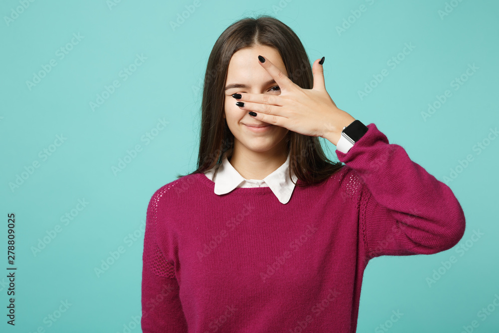 Young brunette woman girl in casual clothes posing isolated on blue green turquoise wall background studio portrait. People sincere emotions lifestyle concept. Mock up copy space Cover eyes with hands Young brunette woman girl in casual clothes posing isolated on blue green turquoise wall background studio portrait. People sincere emotions lifestyle concept. Mock up copy space Cover eyes with hands