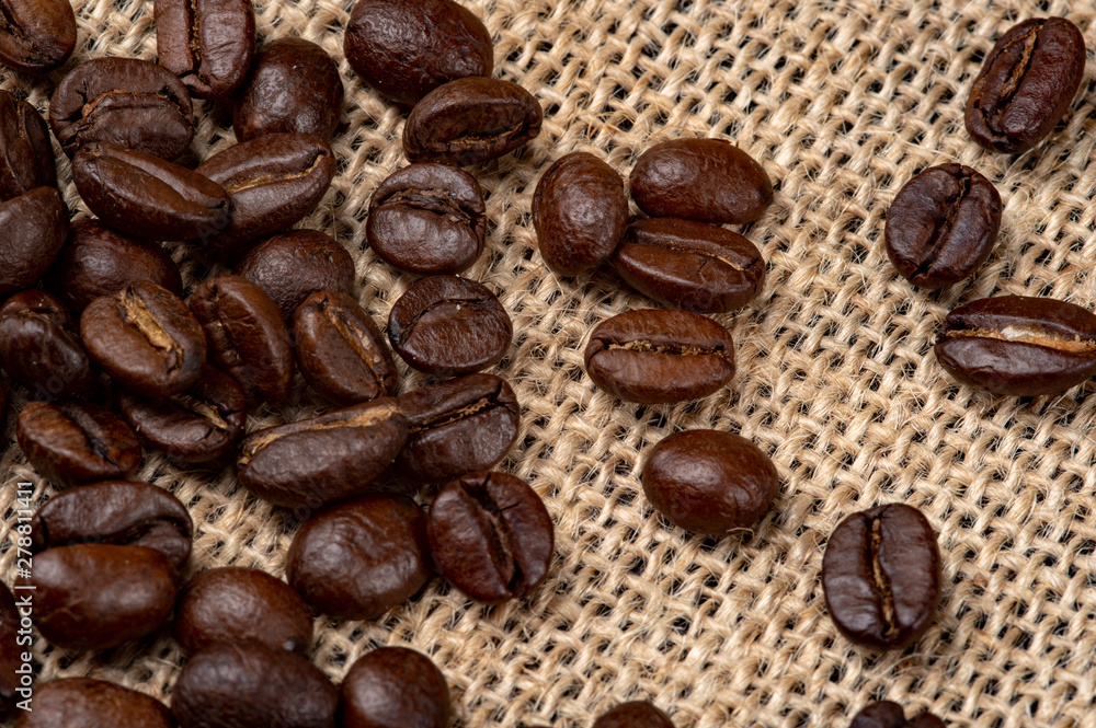 Fototapeta premium Coffee Beans Arabica Canvas Background. Close-up photo.