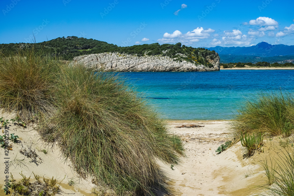 Voidokilia Beach, popular white sand and blue clear water beach in Messinia in Mediterranean area in shape of Greek letter omega, Peloponnese, Greece. Voidokilia Beach, popular white sand and blue clear water beach in Messinia in Mediterranean area in shape of Greek letter omega, Peloponnese, Greece.