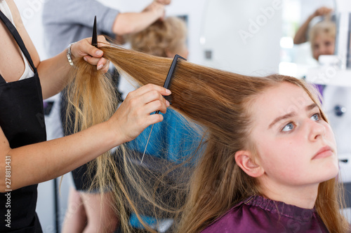 Closeup of teen girl getting haircutting