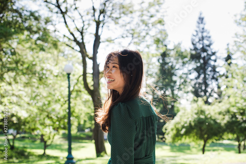 Smiling young woman standing outdoors