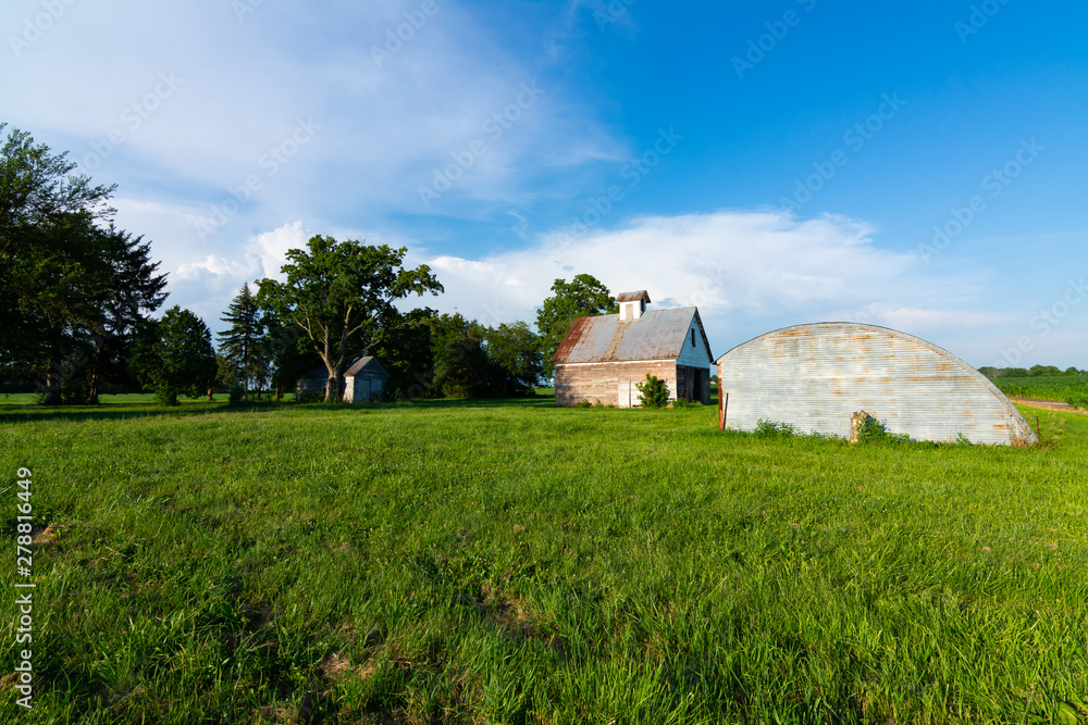 Old barn in grass field