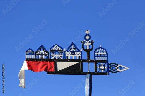 Nida, Lithuania - 04/21/2009: A traditional carved wooden weather vane, which local fishermen put on the mast of a boat.