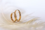Wedding delicate background with rings and feather. Tenderness, tender love concept.