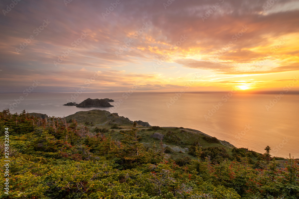 Beautiful sunset over the rugged rocky shore of Newfoundland. North coast of Twillingate, near Long Point Lighthouse. 