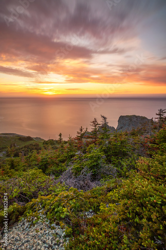 Beautiful sunset over the rugged rocky shore of Newfoundland. North coast of Twillingate, near Long Point Lighthouse. 