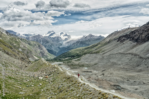 young woman  hiking on the moraine above Zmutt glacier near Zermatt  Cantone Valais  Wallis  Switzerland