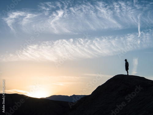 silhouette of a man on the top of a mountain