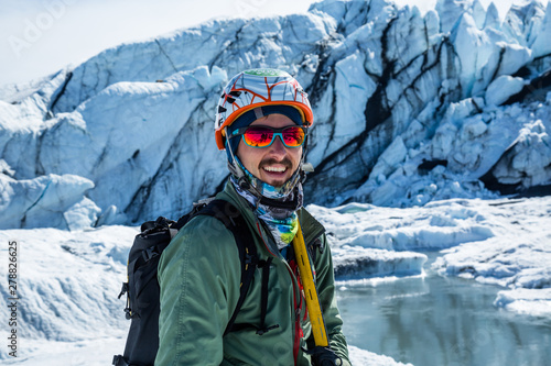 Professional ice climbing guide in front of the icefall of the Matauska Glacier.