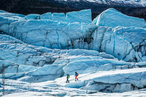 Canvas-taulu Two glacier guides walking among large crevasses and seracs on top of the Matanuska Glacier in Alaska