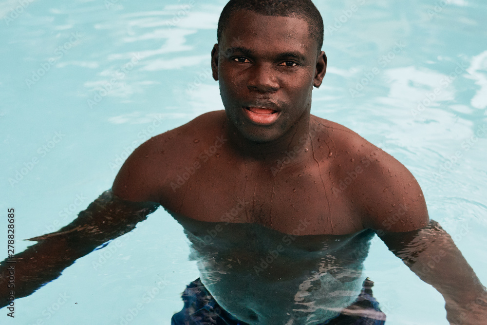 young man in swimming pool young man in swimming pool