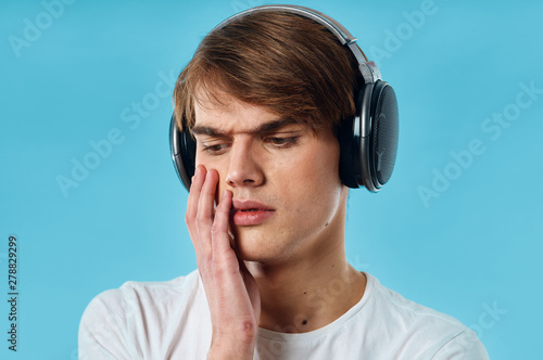 young man listening to music with headphones