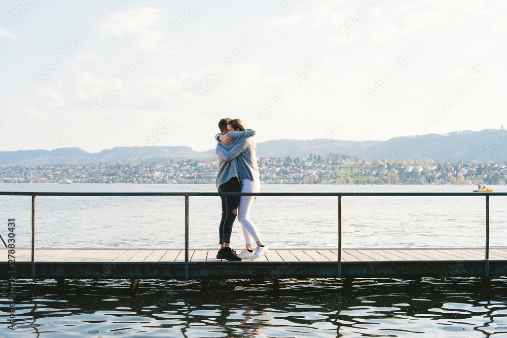 Young couple hugging each other on jetty at Lake Zurich, Zurich, Switzerland Young couple hugging each other on jetty at Lake Zurich, Zurich, Switzerland