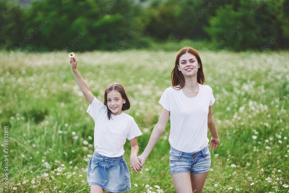 mother and daughter having fun in the park mother and daughter having fun in the park