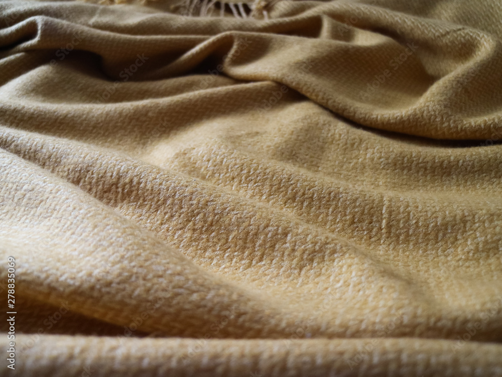Fototapeta premium Messy yellow blanket with texture 