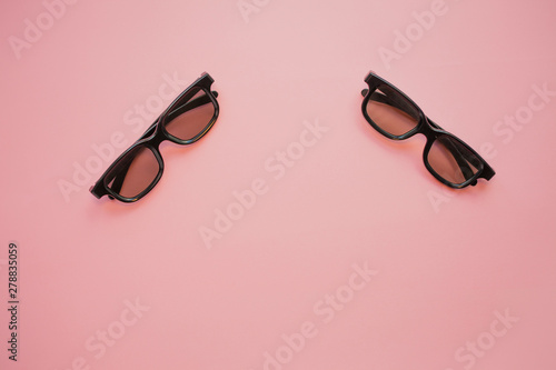 3D cinema, glasses for cinema on a pink background.