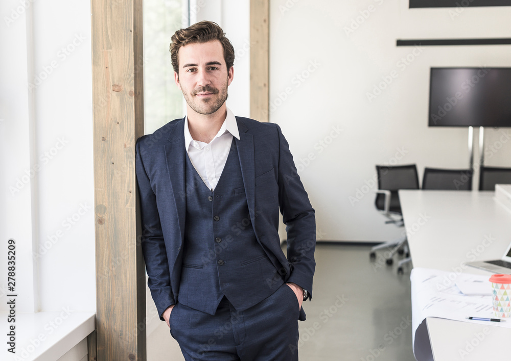 Confident businessman standing in boardroom Confident businessman standing in boardroom