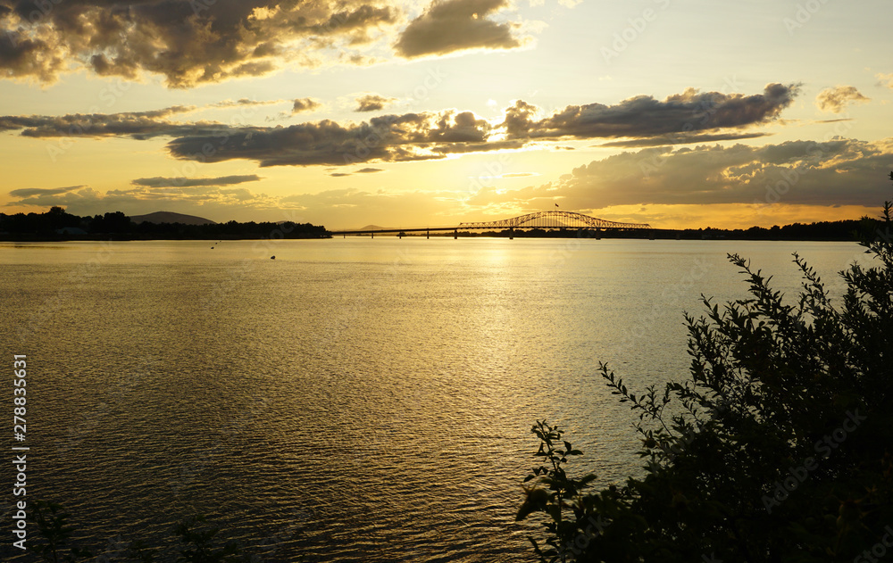 Sunset on river with bridge