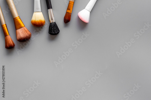 Instruments for make up with brushes on gray background top view mock up photo