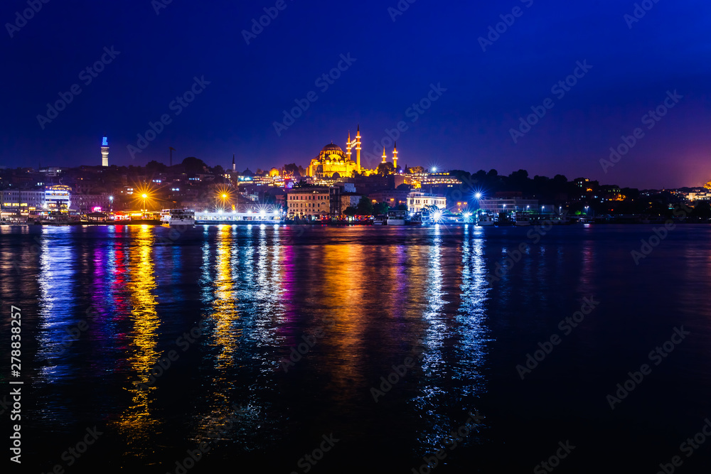 Night view of Istanbul. Panorama cityscape of famous tourist destination Golden Horn bay part of Bosphorus strait. Travel illuminated landscape Bosporus, Turkey, Europe and Asia.
