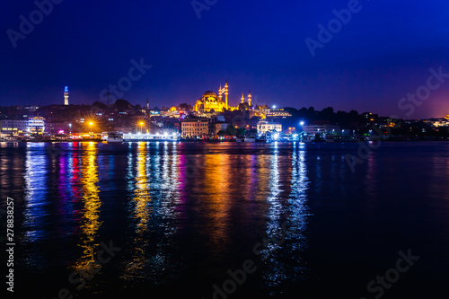 Night view of Istanbul. Panorama cityscape of famous tourist destination Golden Horn bay part of Bosphorus strait. Travel illuminated landscape Bosporus, Turkey, Europe and Asia. © oleg_p_100