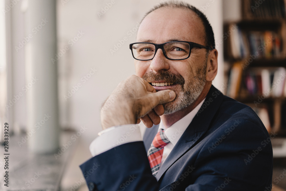Portrait of smiling mature businessman in a cafe Portrait of smiling mature businessman in a cafe
