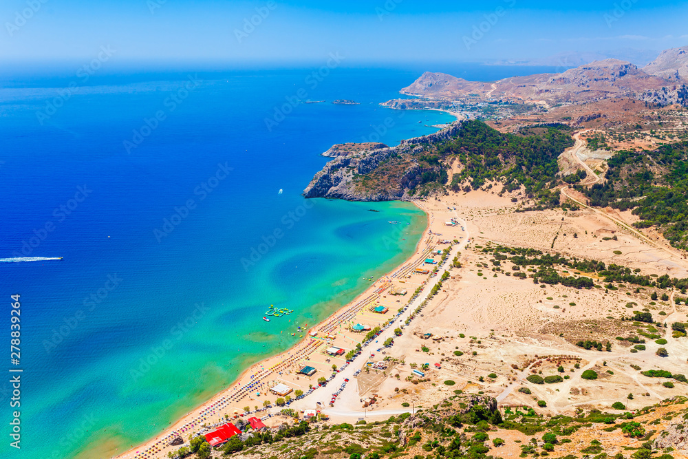 Sea skyview landscape photo Tsambika bay on Rhodes island, Dodecanese, Greece. Panorama with nice sand beach and clear blue water. Tsampika is a famous tourist destination in South Europe Sea skyview landscape photo Tsambika bay on Rhodes island, Dodecanese, Greece. Panorama with nice sand beach and clear blue water. Tsampika is a famous tourist destination in South Europe